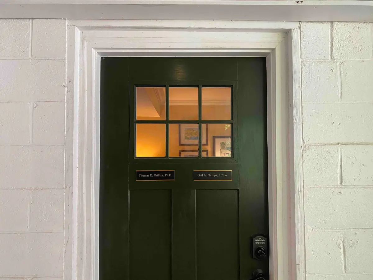 The dark green private entrance door with brass nameplates