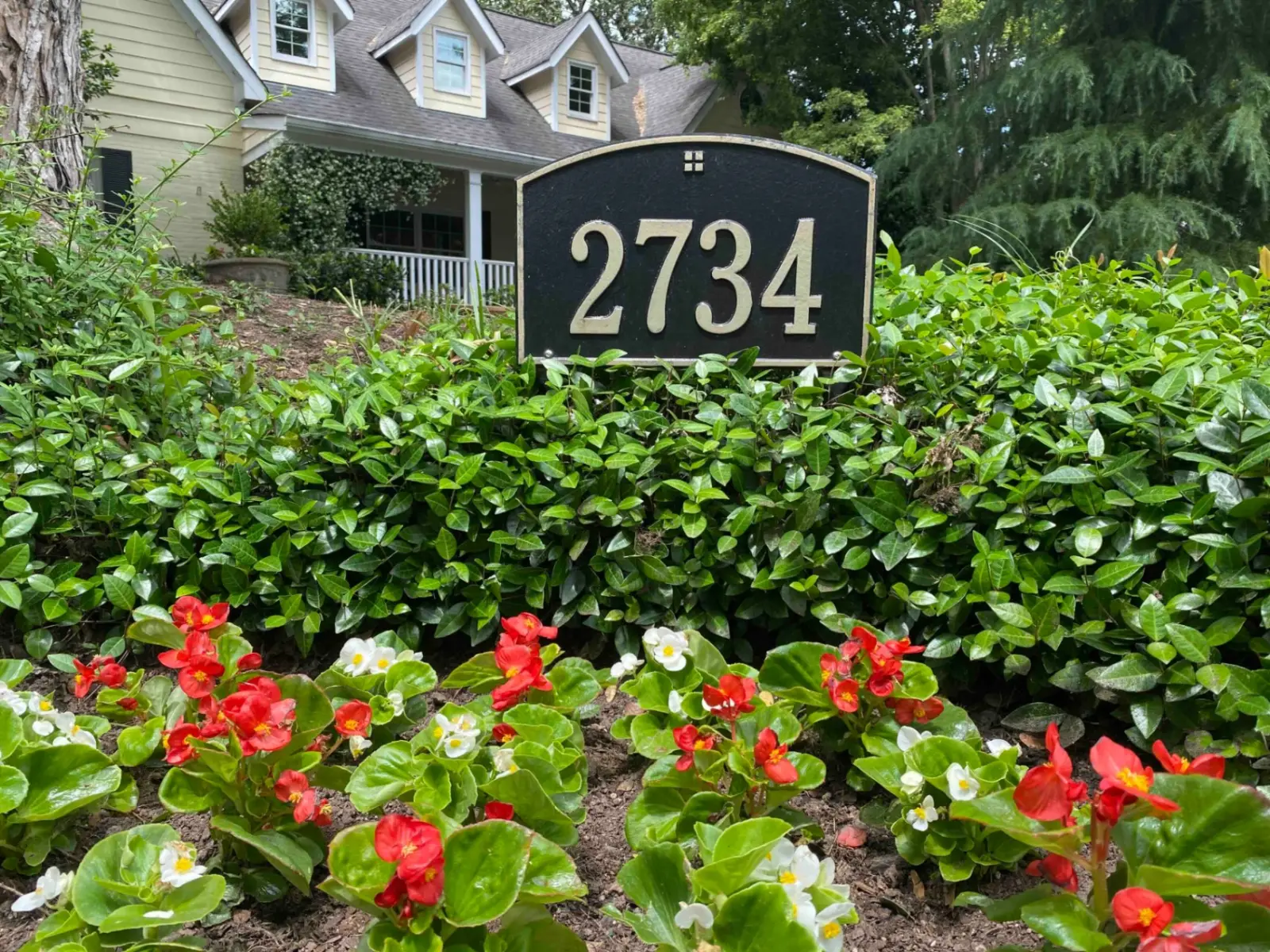 The exterior of the Buckhead home office, surrounded by hedges and seasonal flowers